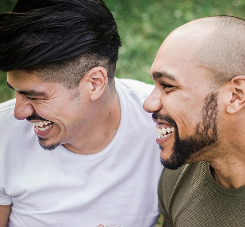 Two adult males smiling
