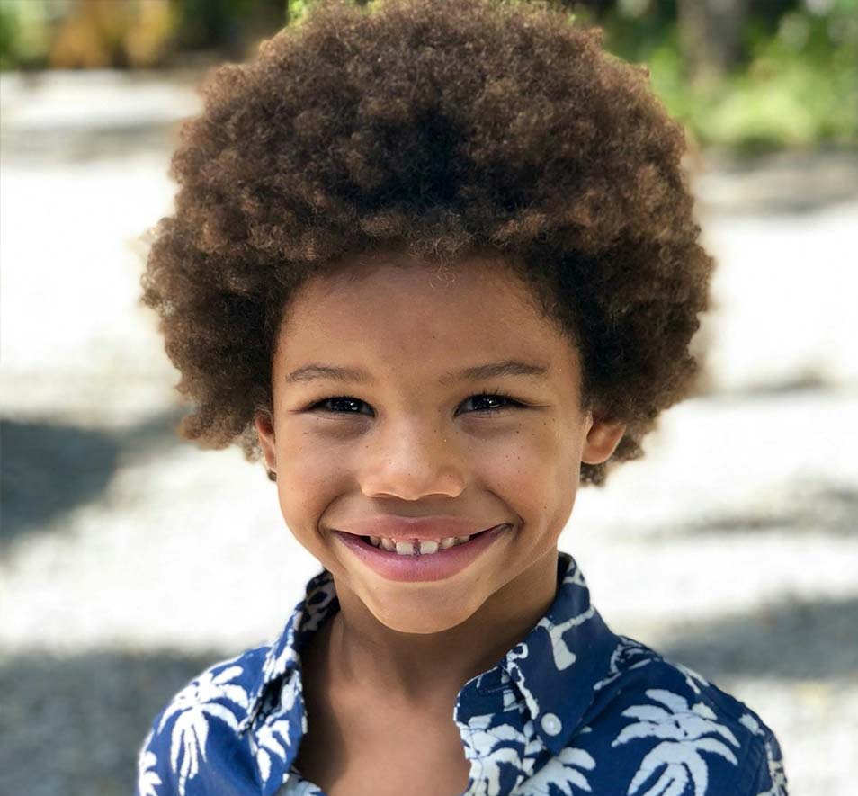 Young boy smiling during early orthodontic care