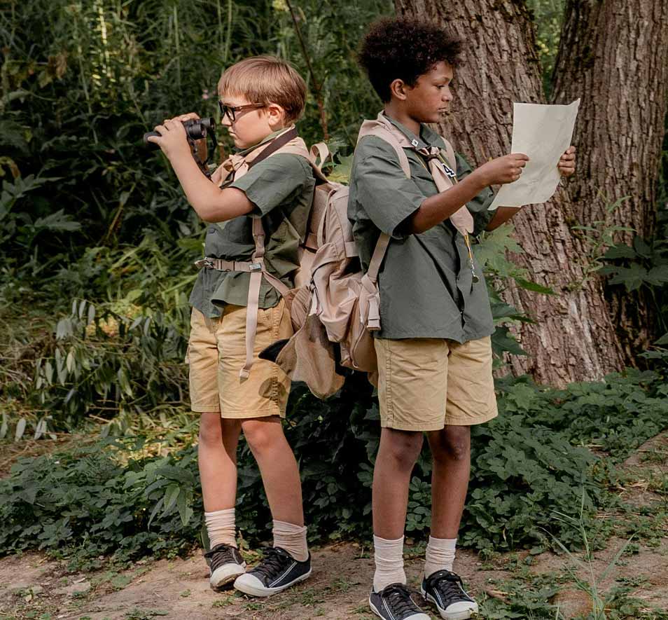 2 young scouts looking at a map to find something